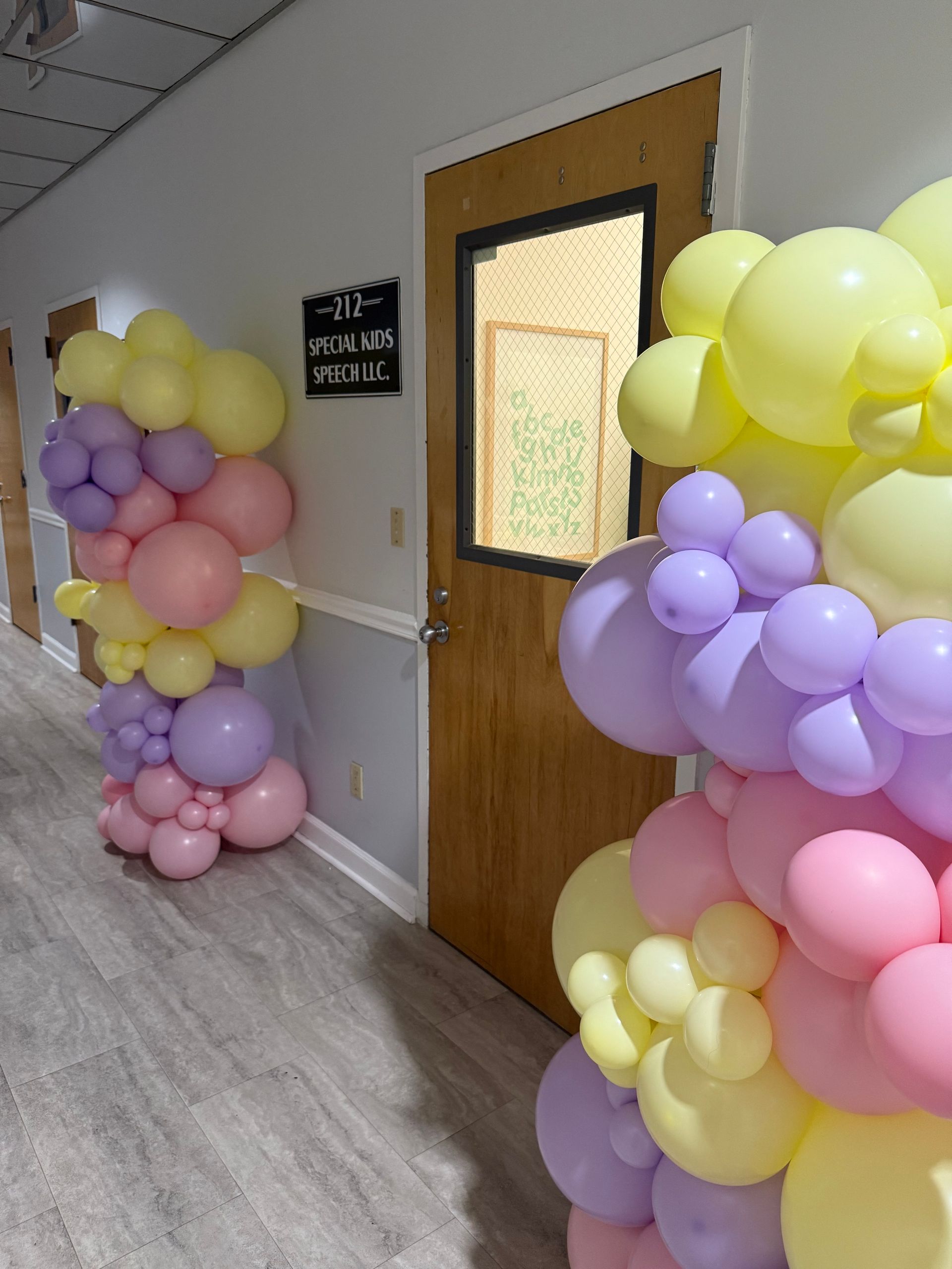A hallway with balloons and a sign that says 30