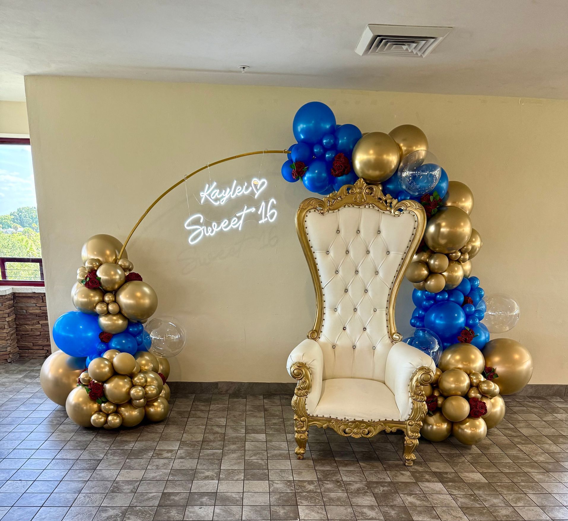 A bunch of balloons are hanging on a wall in front of a door.