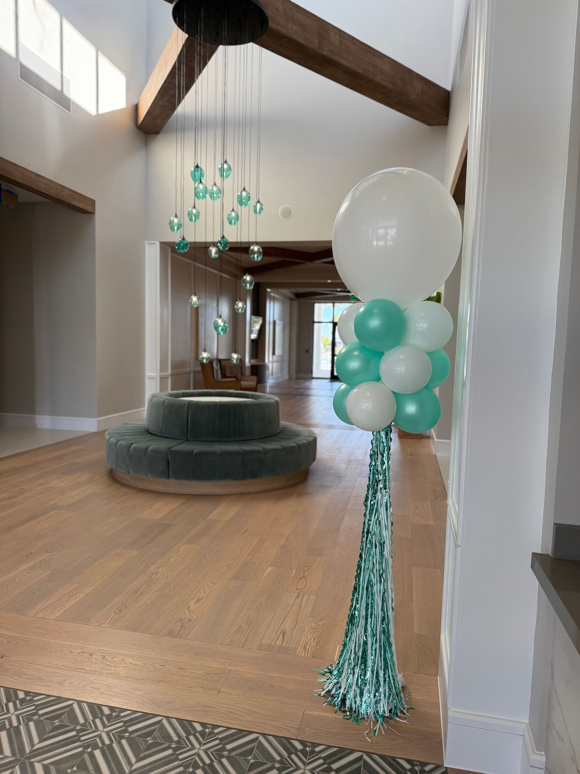 A room with balloons on a pole in the middle of it.