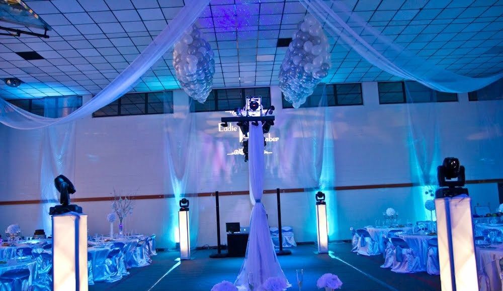 A large room with tables and chairs decorated in blue and white.
