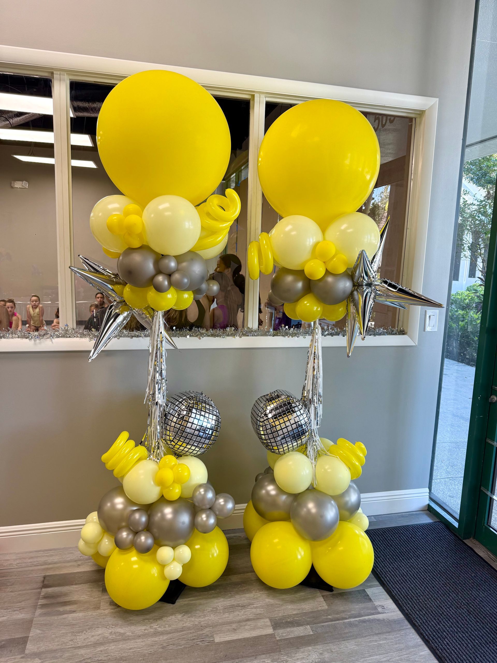 A couple of balloons sitting on top of each other in a room.
