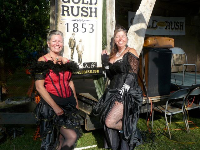 Two women dressed in period costume.
