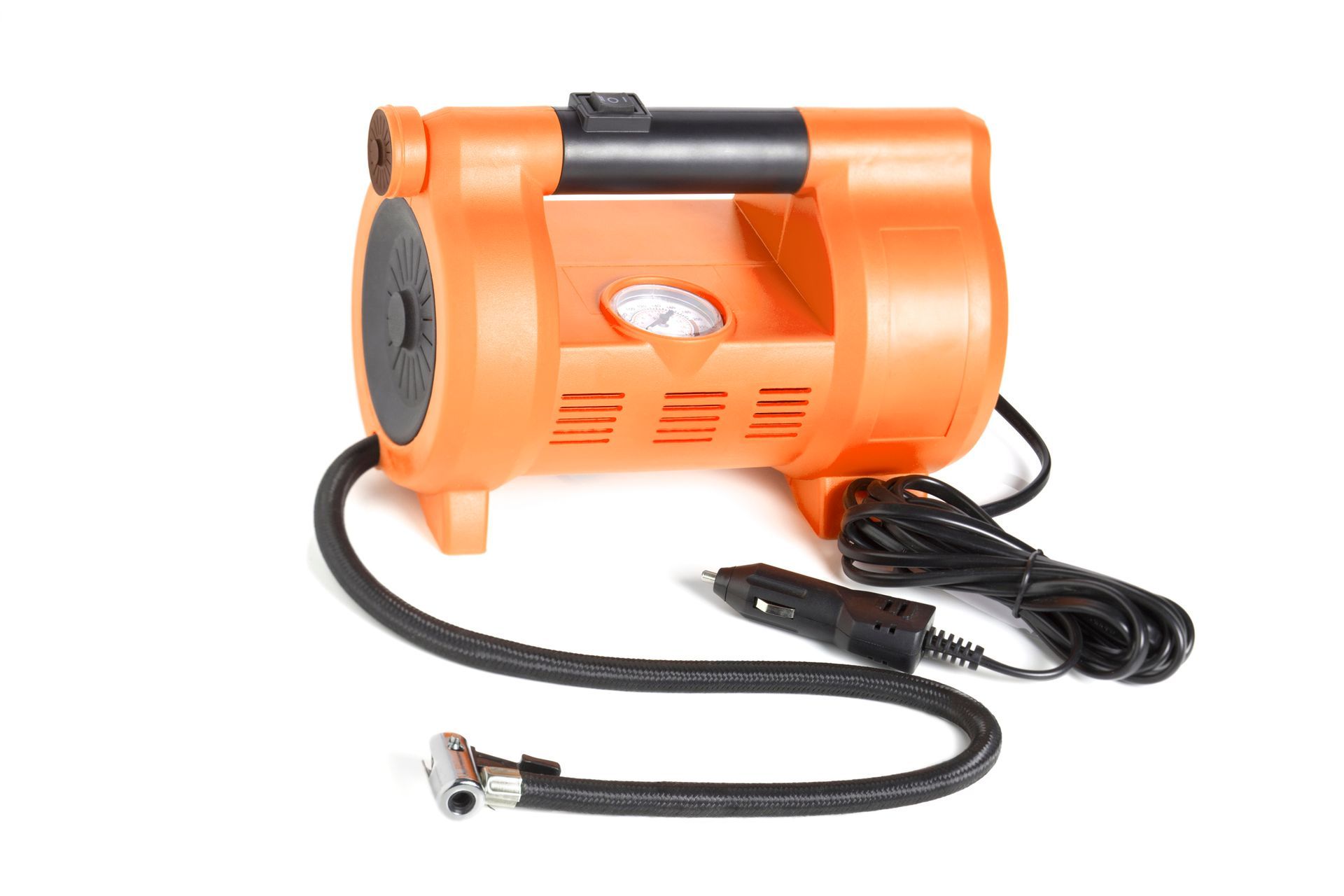 An orange air compressor with a hose attached to it on a white background.