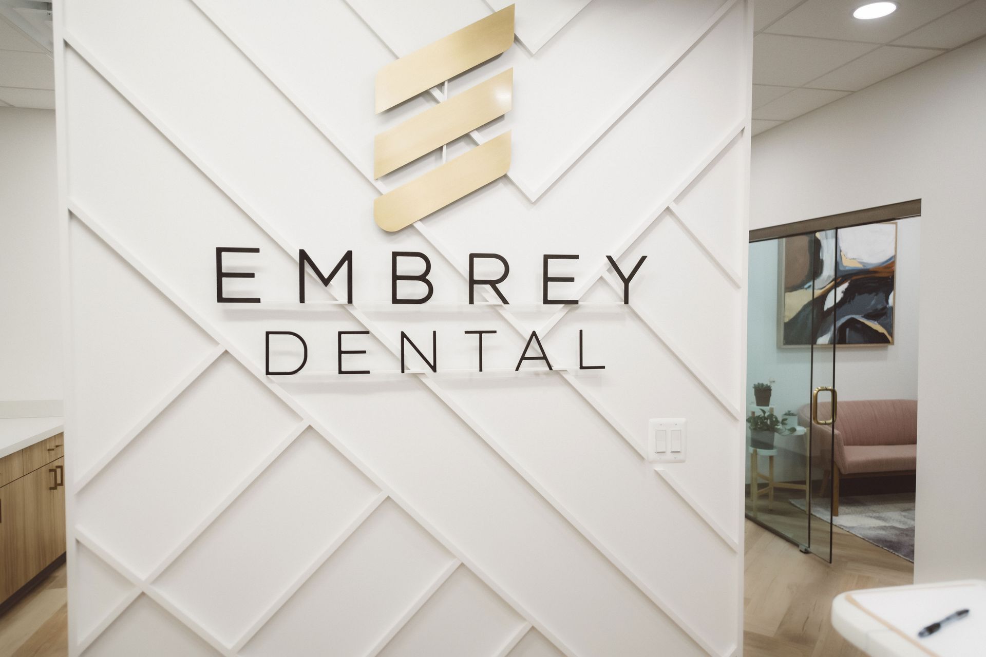 embrey dental logo and front office background