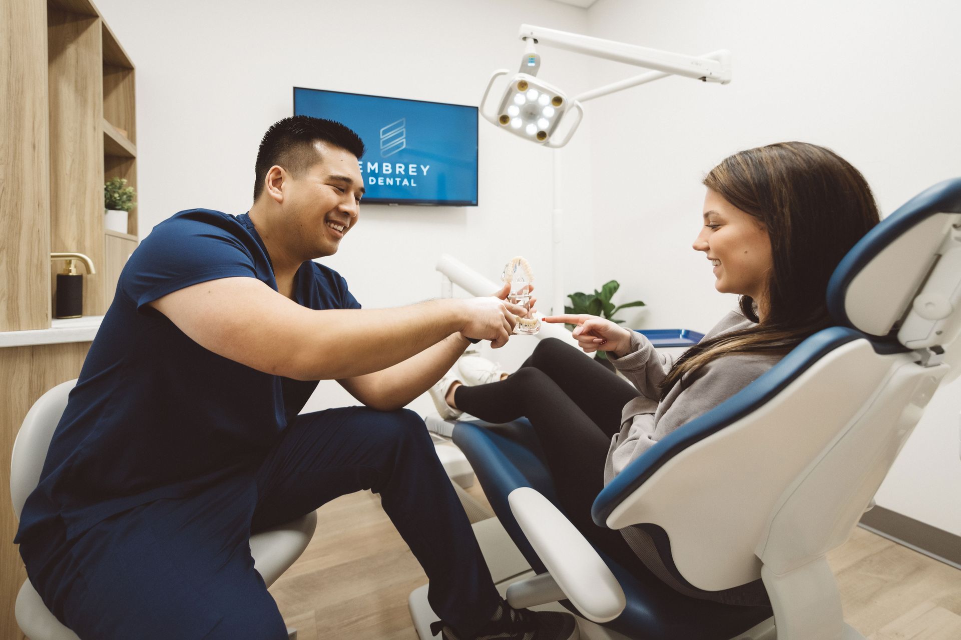 Dr Lim talking with a patient in the dental chair