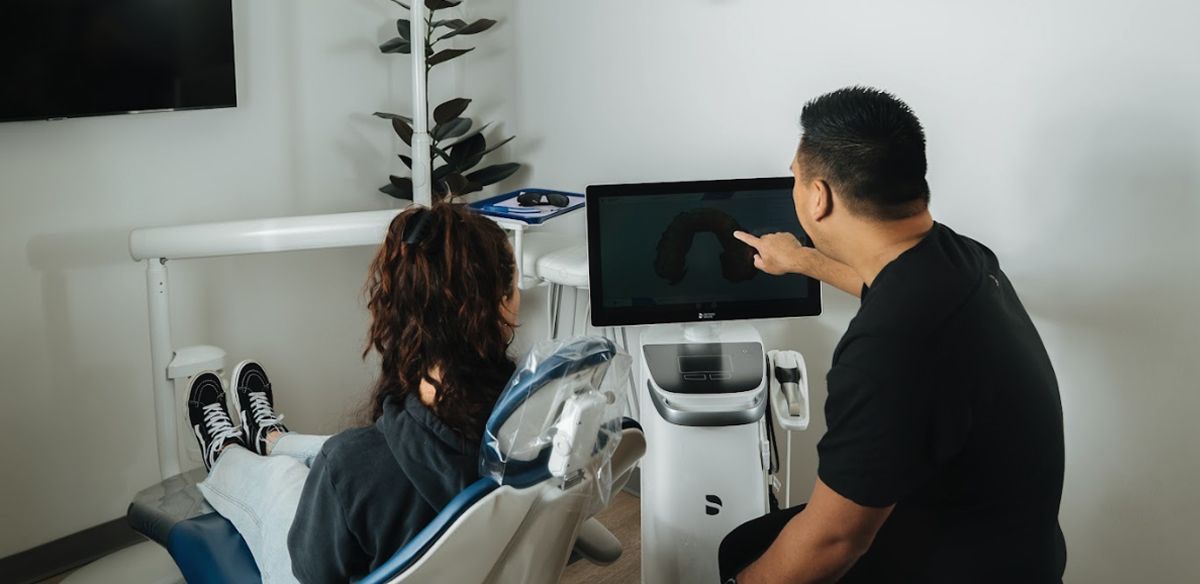 Two people examining an ultrasound scan in a medical office