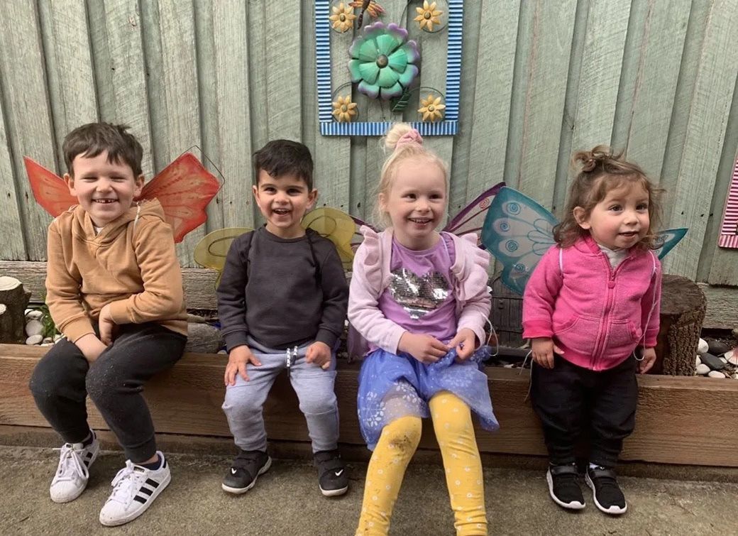 Child playing with colorful stacking toy, stacking blocks on a table.