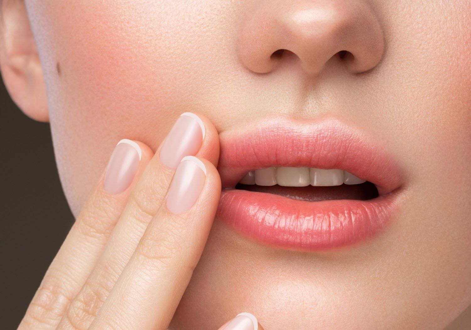 woman having lines drawn on her face for surgery