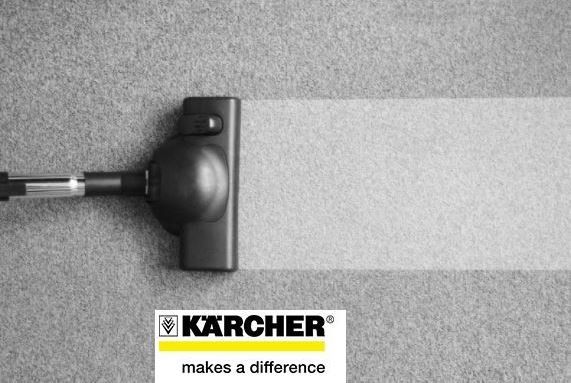 Close-up man using a vacuum cleaner while cleaning in the room