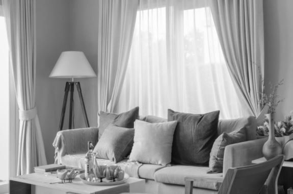 Close-up of blue and pink elegant button down shirts are hanging on wooden hangers.