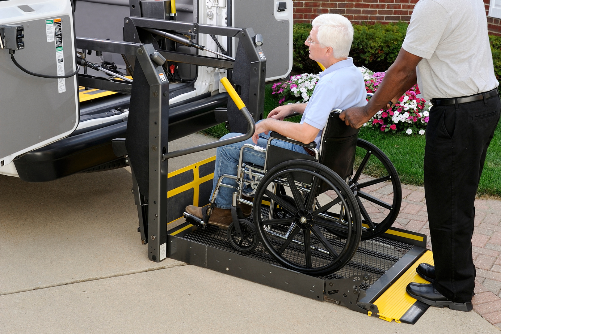 a man in a wheelchair is being lifted into a van