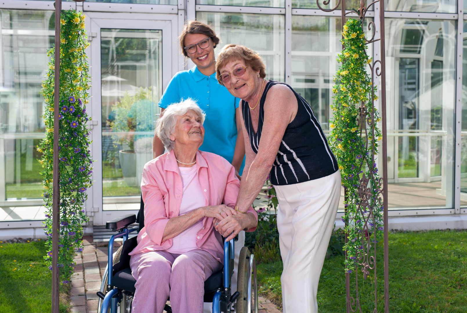 a woman in a wheelchair is being helped by two other women .