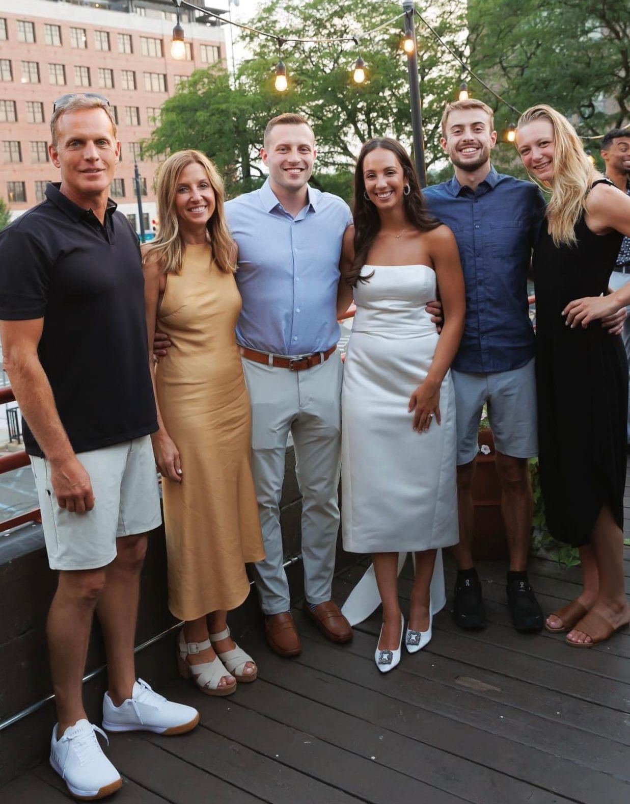 A group of people posing for a picture on a deck