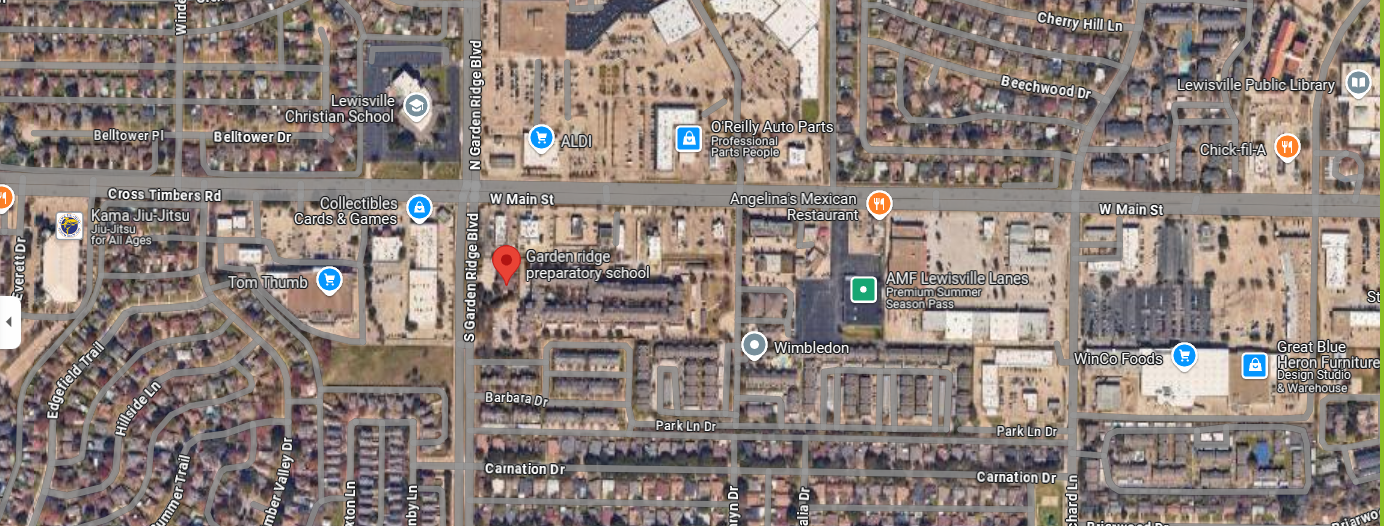 An aerial view of a residential area with lots of buildings and lots of cars.