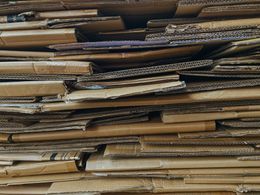 Pile of flattened corrugated cardboard pieces.