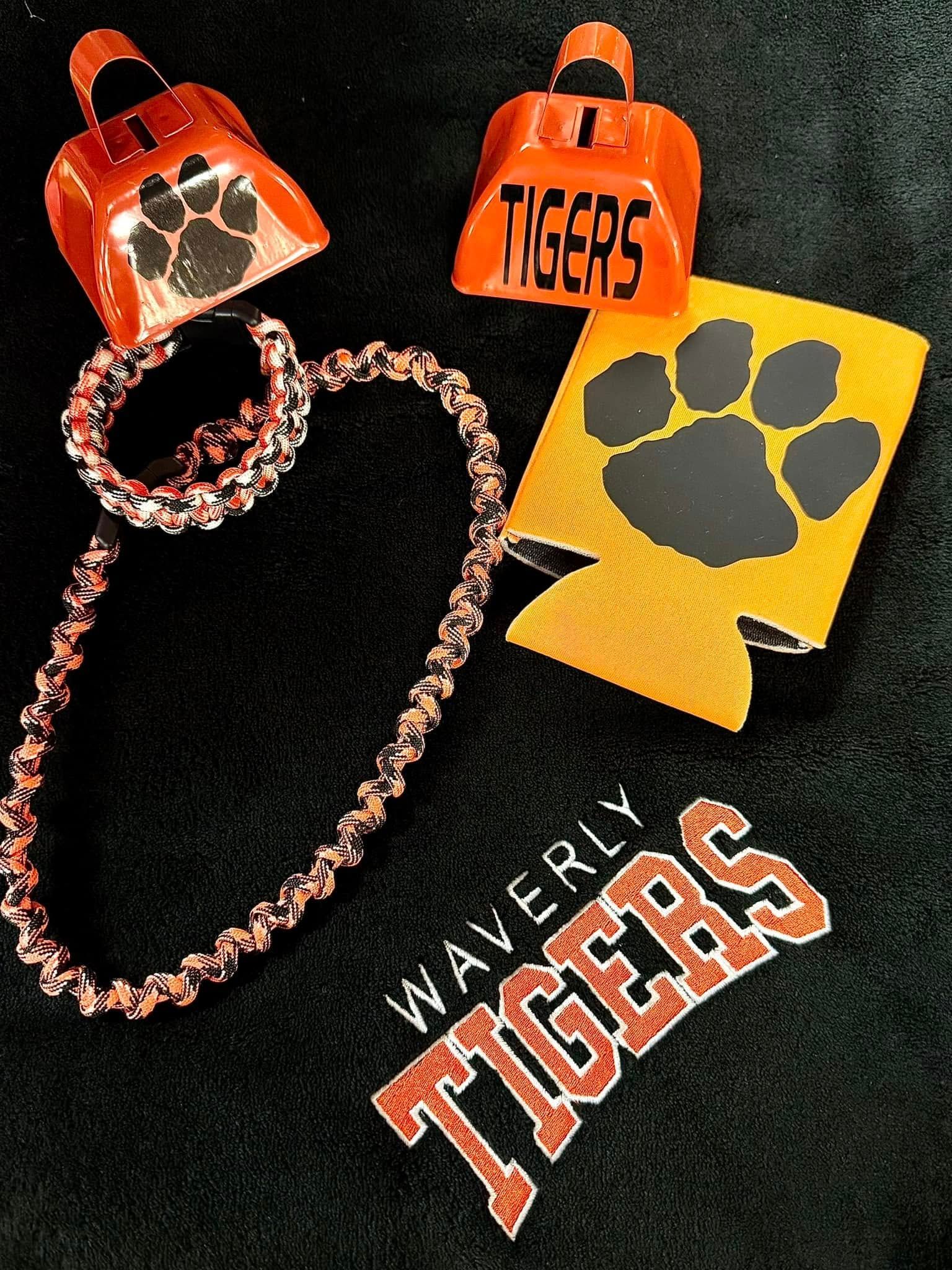 A tigers necklace a bell and a can holder