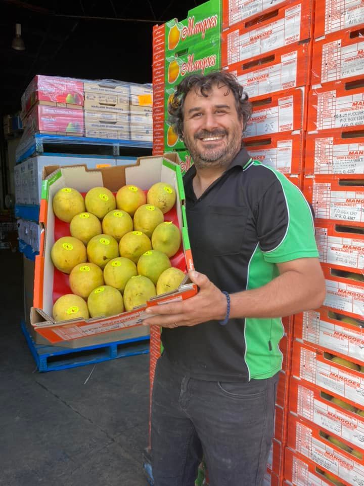 Man Smiling While Holding Box Of Fruit — Start Fresh Fruit Market in Bundaberg Central QLD