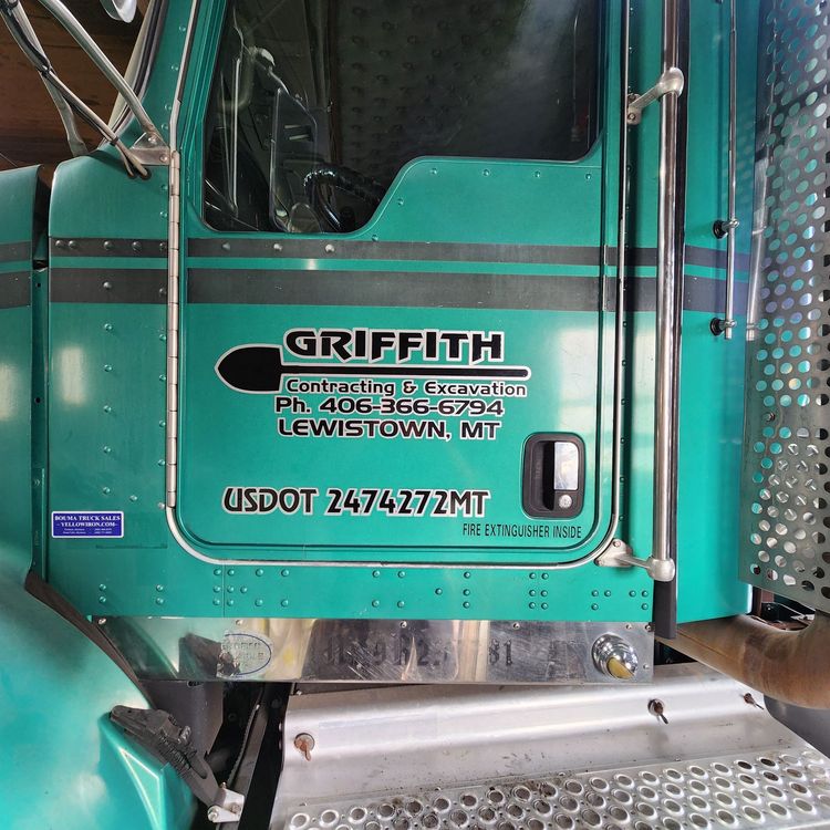 Outdoor bar with gray stone patio, black ceiling, fireplaces, and bar stools.