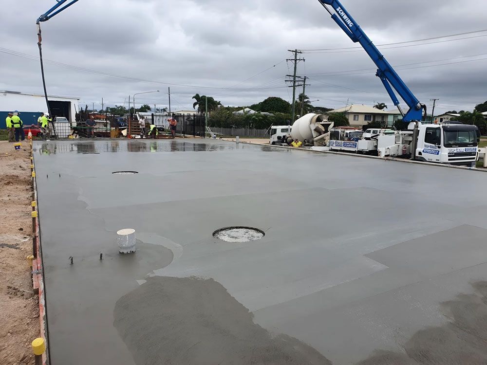 Large Concrete Slab With Concrete Mixer Truck In The Background — Ingham Concrete–Icon in Ingham, QLD