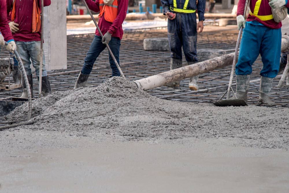 Pouring ready-mix concrete onto the flooring — Ingham Concrete–Icon in Cardwell, QLD