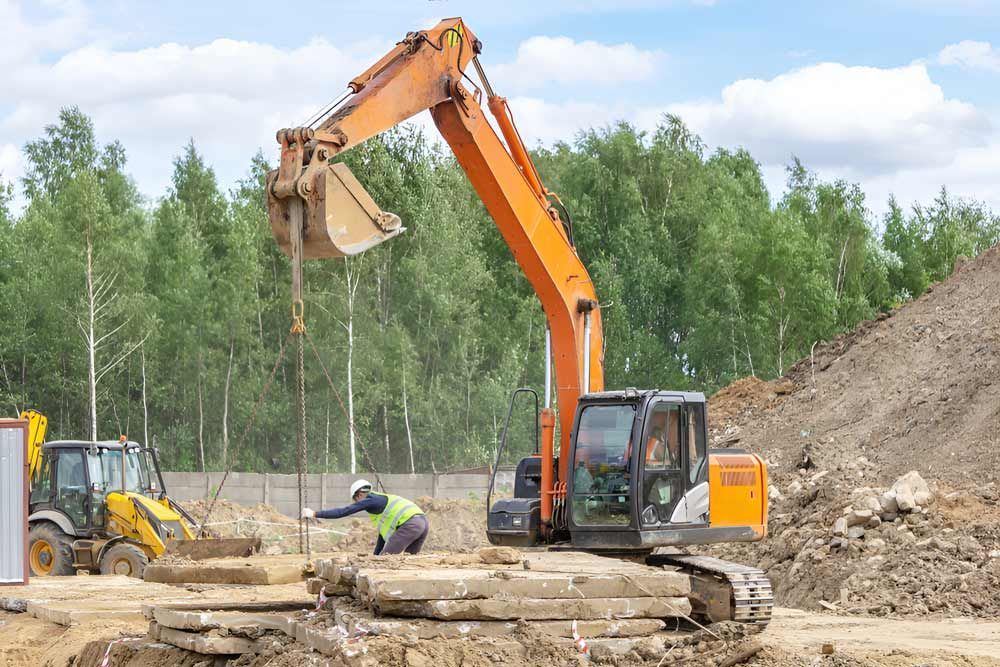 Loading Of Road Plates With The Help Of An Excavator — Ingham Concrete–Icon in Ingham, QLD