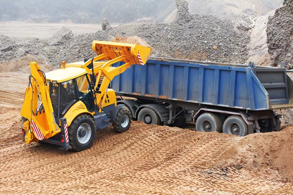 Wheel Loader Excavator Loading Sand Into Dumper Truck — Ingham Concrete–Icon in Cardwell, QLD