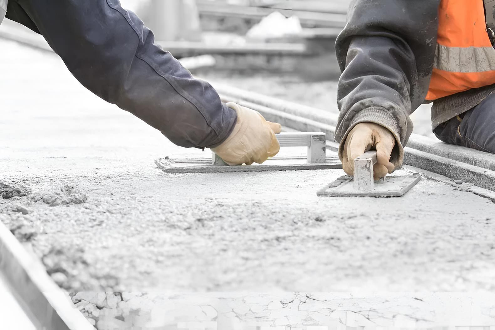 Two Construction Workers Are Working On A Concrete Surface — Ingham Concrete–Icon in Cardwell, QLD