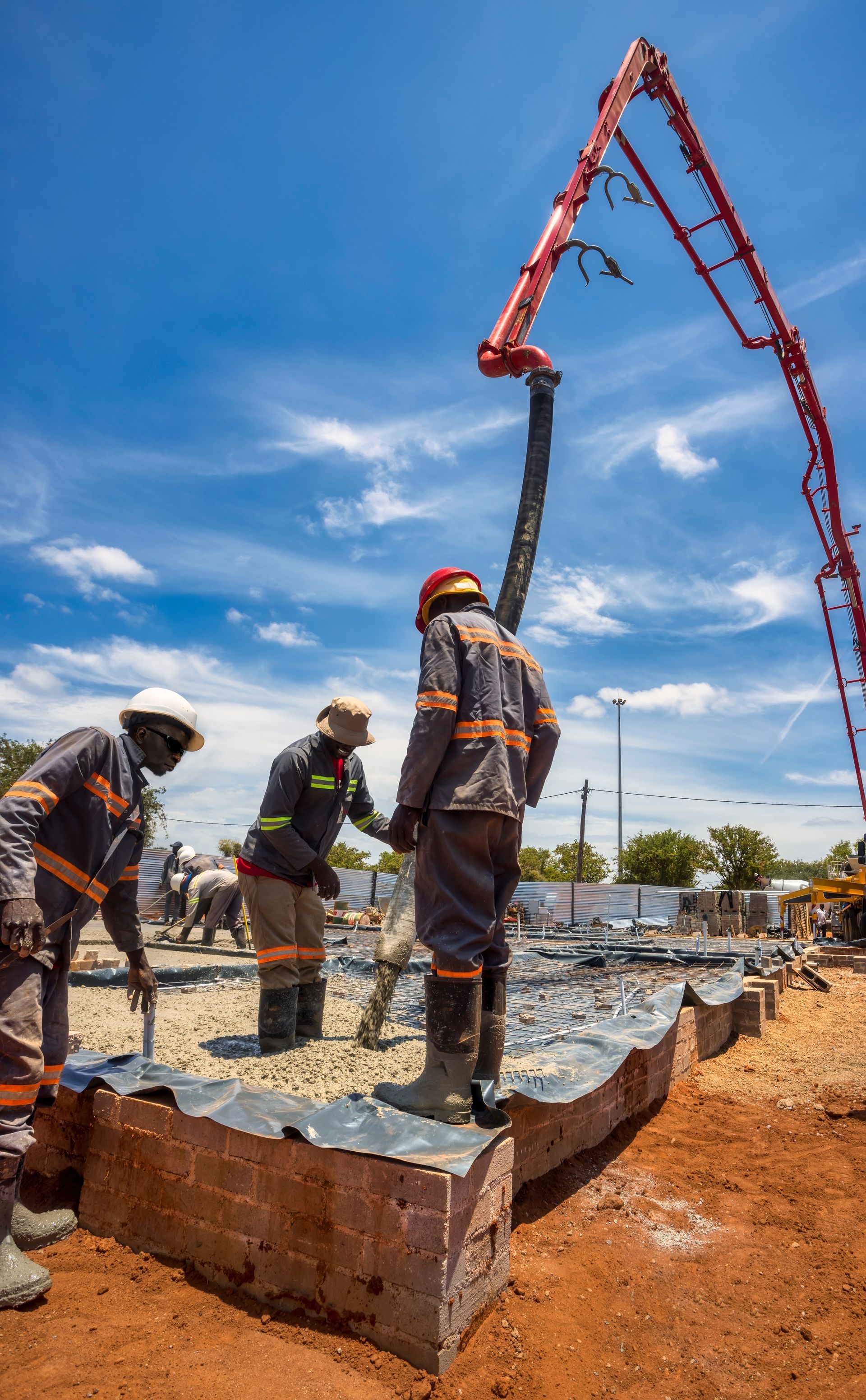 Construction Workers Are Pouring Concrete From The Mixer Truck — Ingham Concrete–Icon in Ingham, QLD