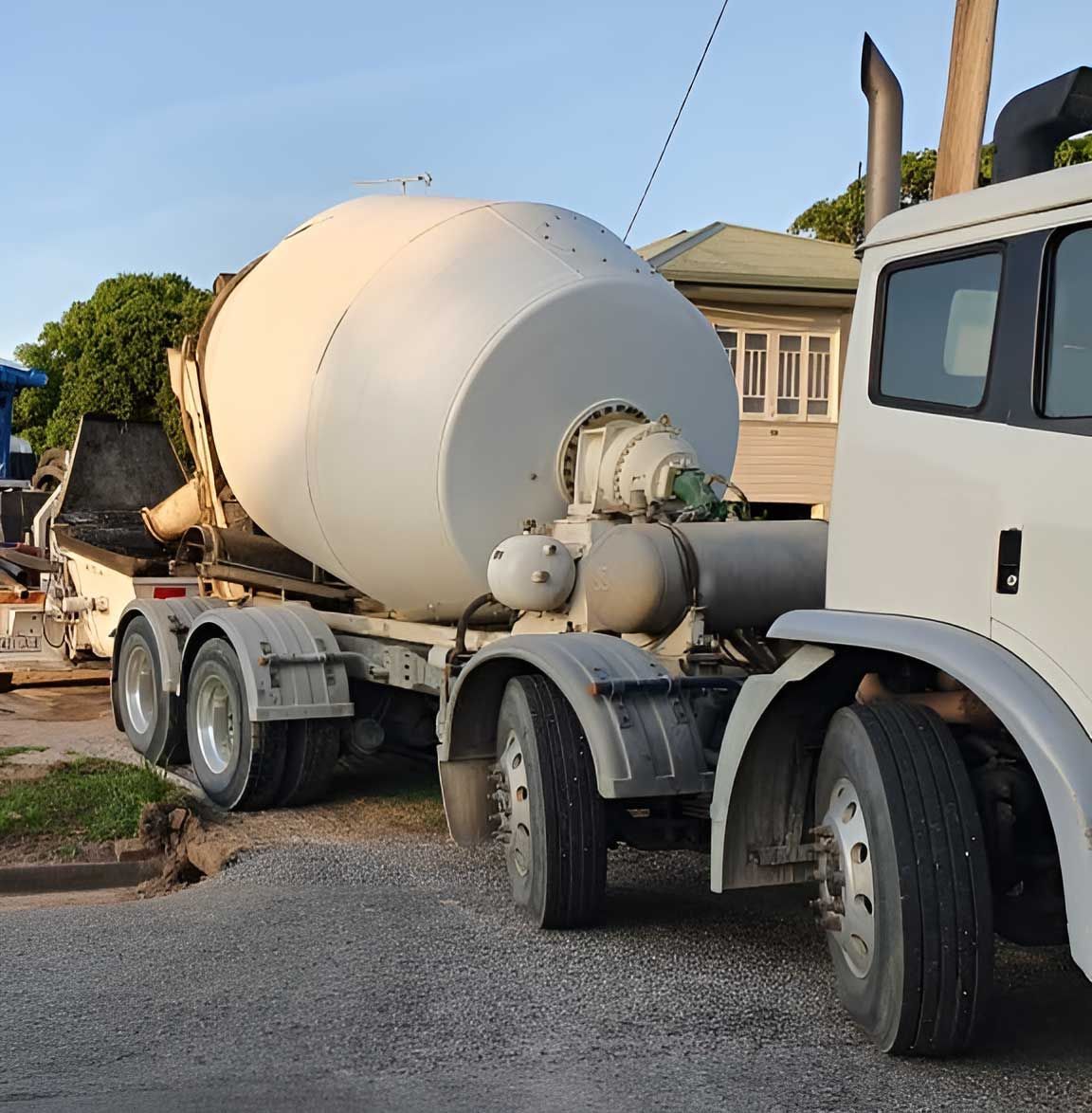 A Concrete Mixer Truck Is Parked In Front Of A House — Ingham Concrete–Icon in Ingham, QLD