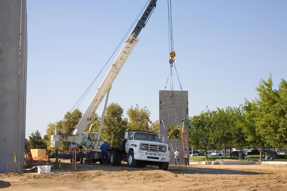 A Truck Crane Is Lifting The Concrete Panels — Ingham Concrete–Icon in Cardwell, QLD