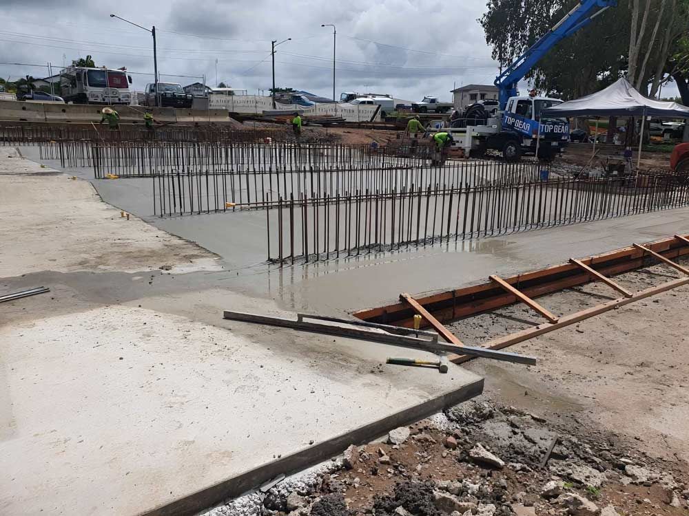 A Construction Site With A Crane Pumping Concrete Into The Ground — Ingham Concrete–Icon in Cardwell, QLD