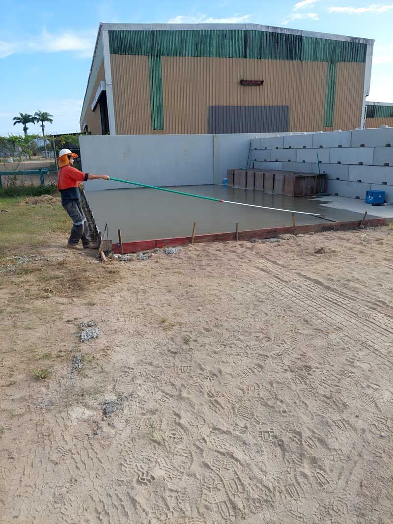 A Man Is Finishing The Concrete Flooring — Ingham Concrete–Icon in Ingham, QLD