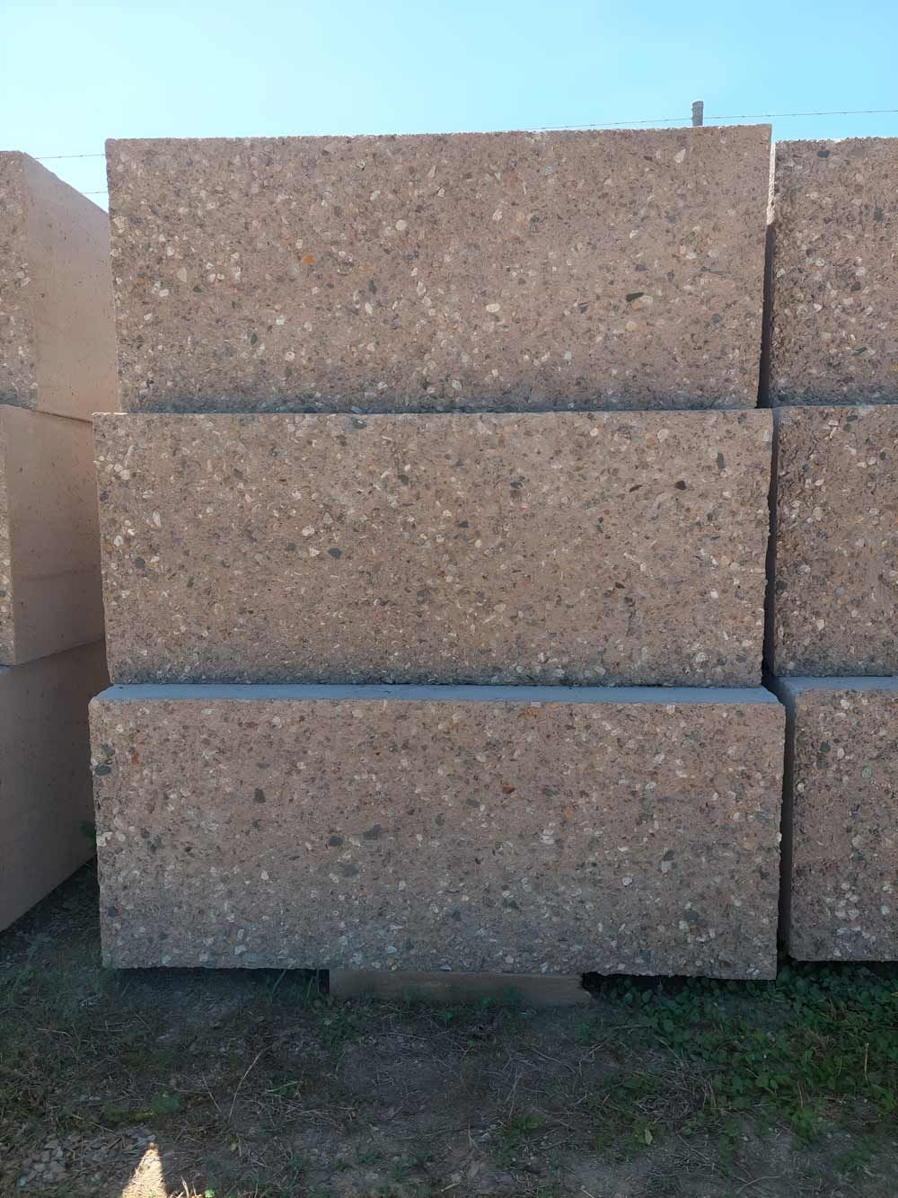 A Stack Of Concrete Blocks Is Placed On Top Of Each Other On The Ground — Ingham Concrete–Icon in Ingham, QLD