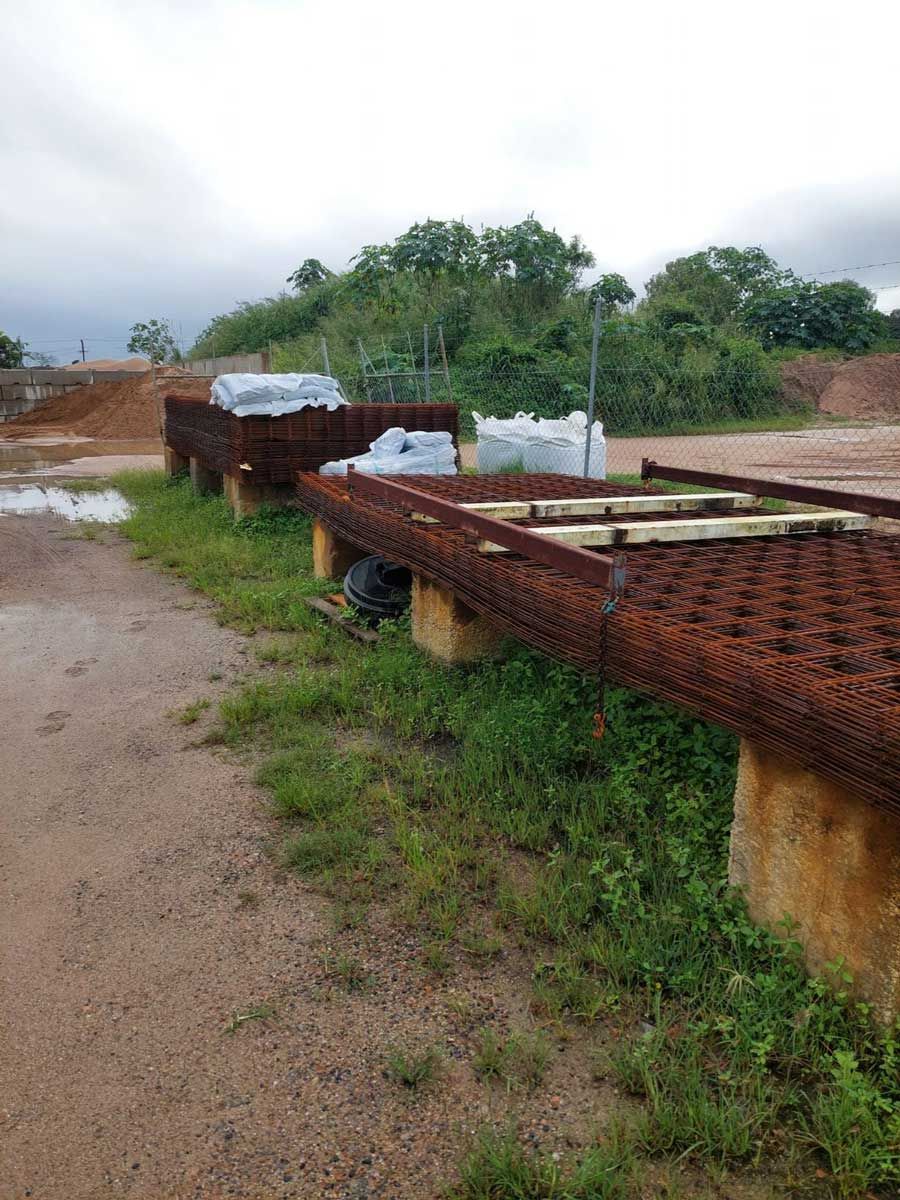 A Row Of Metal Pipes Sitting On Top Of A Dirt Road — Ingham Concrete–Icon in Ingham, QLD