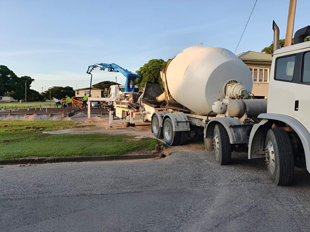 A Concrete Mixer Truck Is Parked On The Side Of The Road — Ingham Concrete–Icon in Ingham, QLD