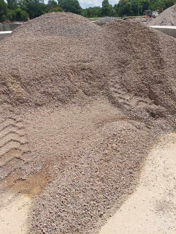 A Pile Of Gravel Is Placed On Top Of A Dirt Field — Ingham Concrete–Icon in Cardwell, QLD