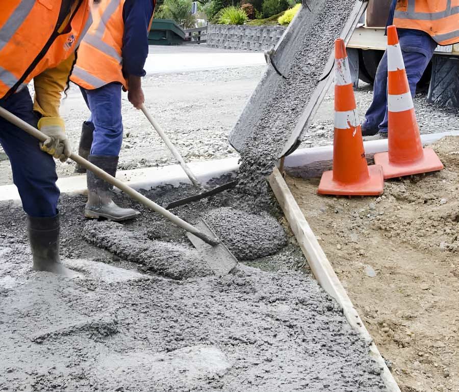 Construction Workers Are Laying Concrete On The Ground — Ingham Concrete–Icon in Ingham, QLD