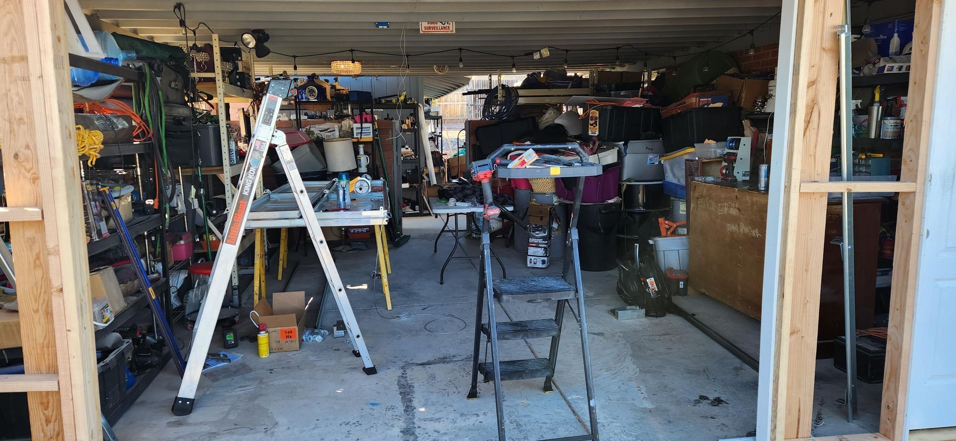 A garage with a ladder and a table in it.