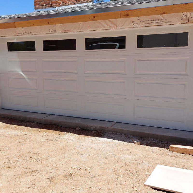 A white garage door with a lot of windows
