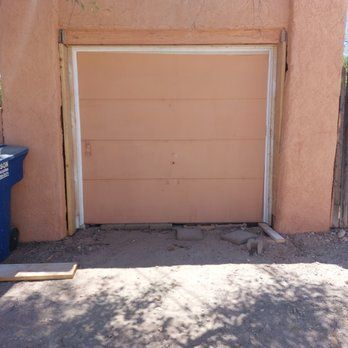 A garage door is being installed on the side of a building.