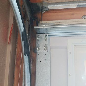 A close up of a garage door with a metal frame.