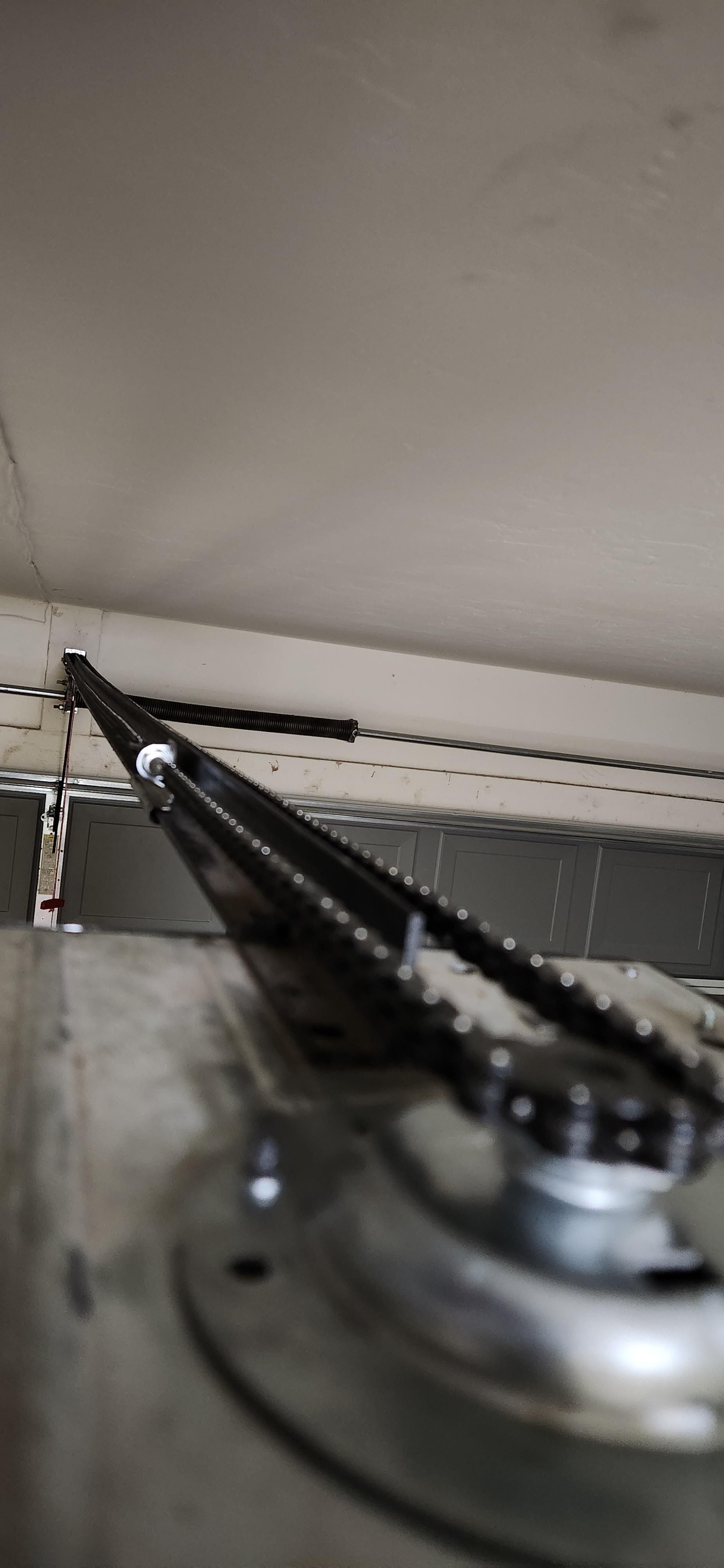 A close up of a piece of metal with a chain attached to it.