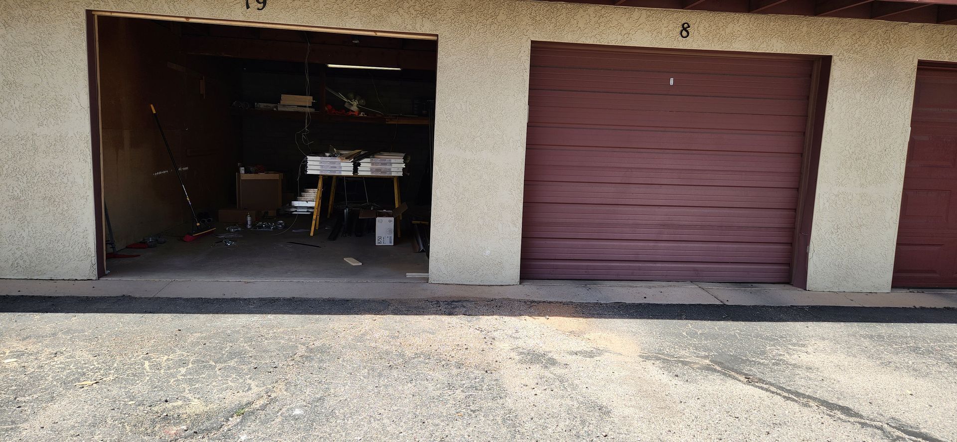 A row of garage doors are open and empty