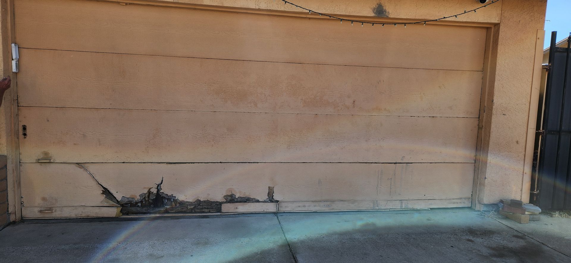 A close up of a garage door with a lot of stains on it.