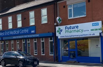 A car is parked in front of future pharmacy