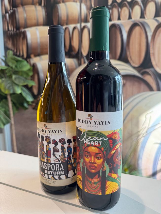 Two bottles of wine are sitting next to each other on a table.
