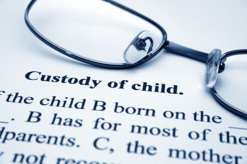 A pair of glasses sits on top of a piece of paper that says custody of child