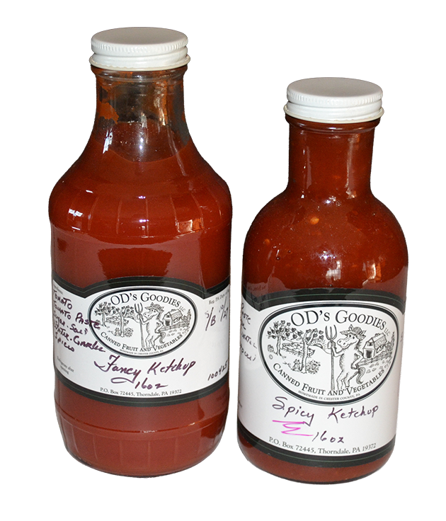 Two bottles of OD's Gourmet ketchup: one savory, one spicy, both with white labels and caps.