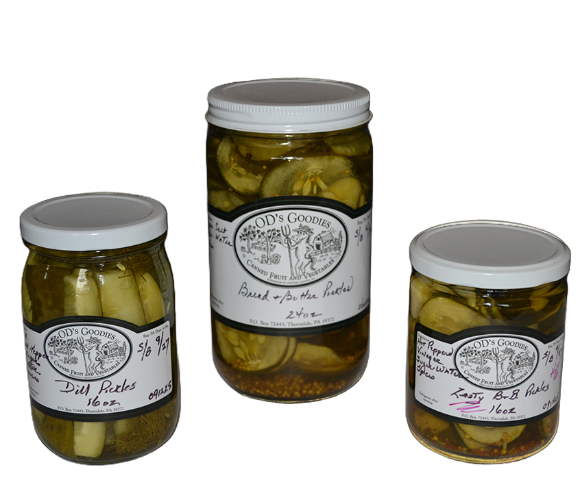 Three jars of pickles with white lids and labels.