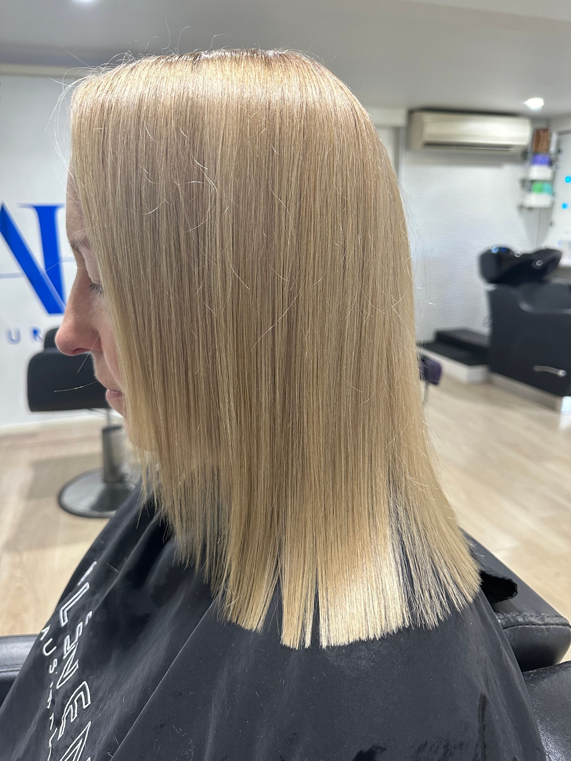 A Woman is Getting Her Hair Dyed by a Hairdresser — Azure Hair in South Mackay, QLD